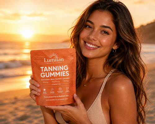 Woman holding a package of Lumilan Tanning Gummies on a beach at sunset